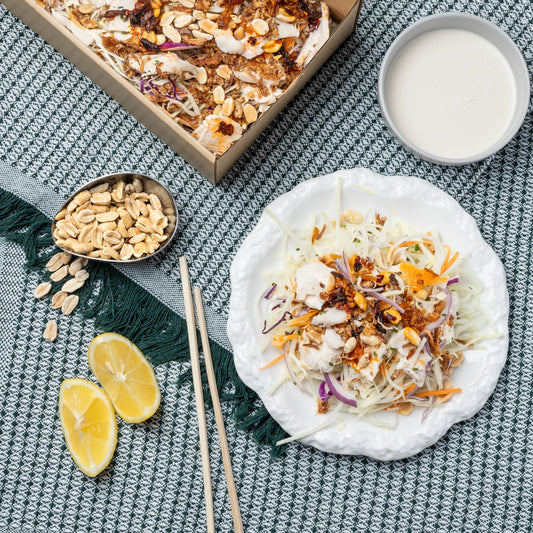 Papaya with shredded chicken, white cabbage, crispy shallots, crispy peanuts, roasted coconut, palm sugar & coconut cream dressing