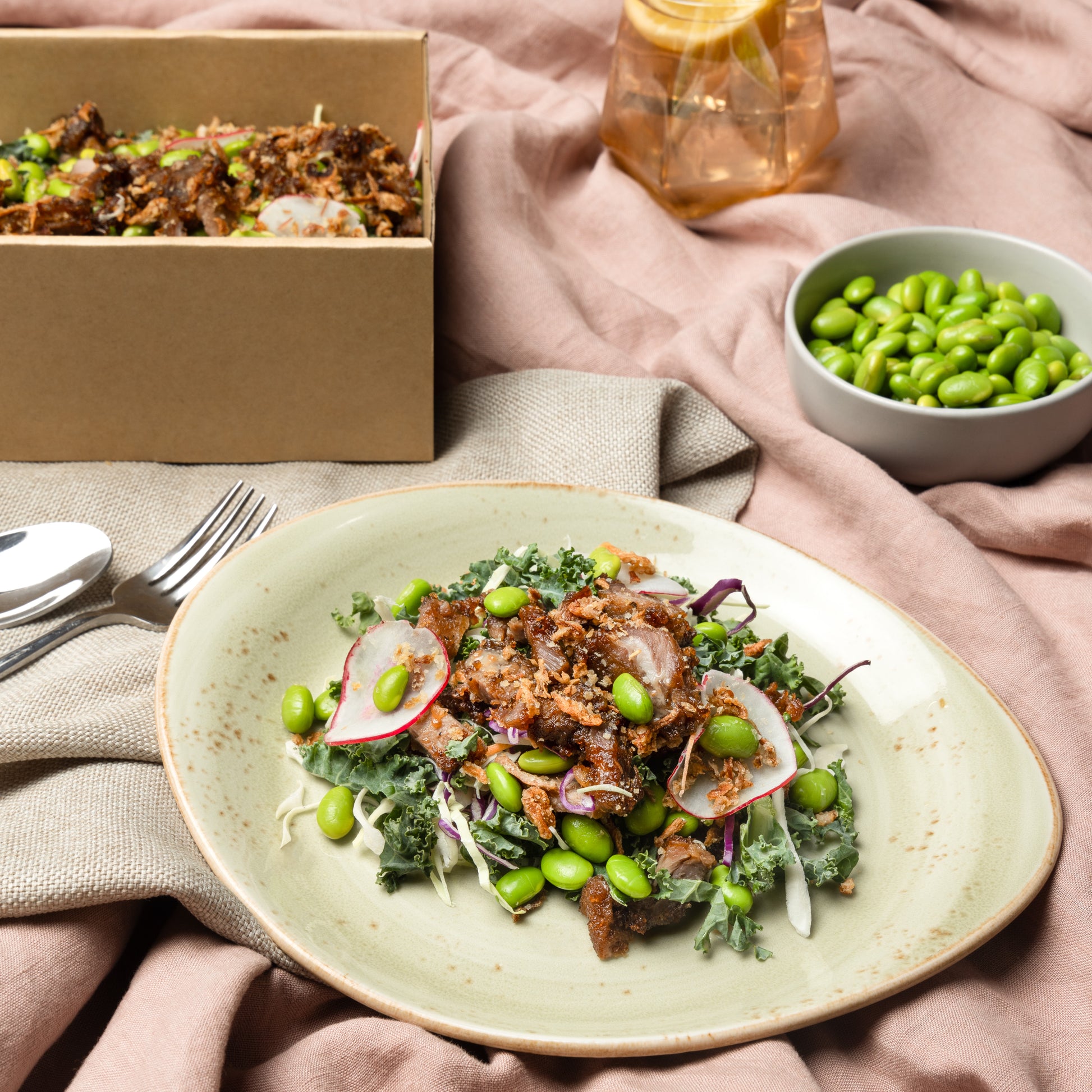 Beef with slaw, shaved carrot, radish, red onion, kale, soy beans, toasted sesame seeds, crispy garlic & roasted sesame dressing