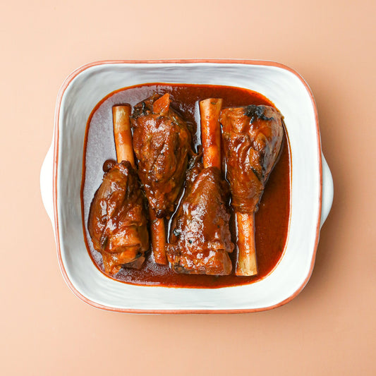 Braised Lamb Shanks with Sauteed Spinach and Reduced Braising Liquor